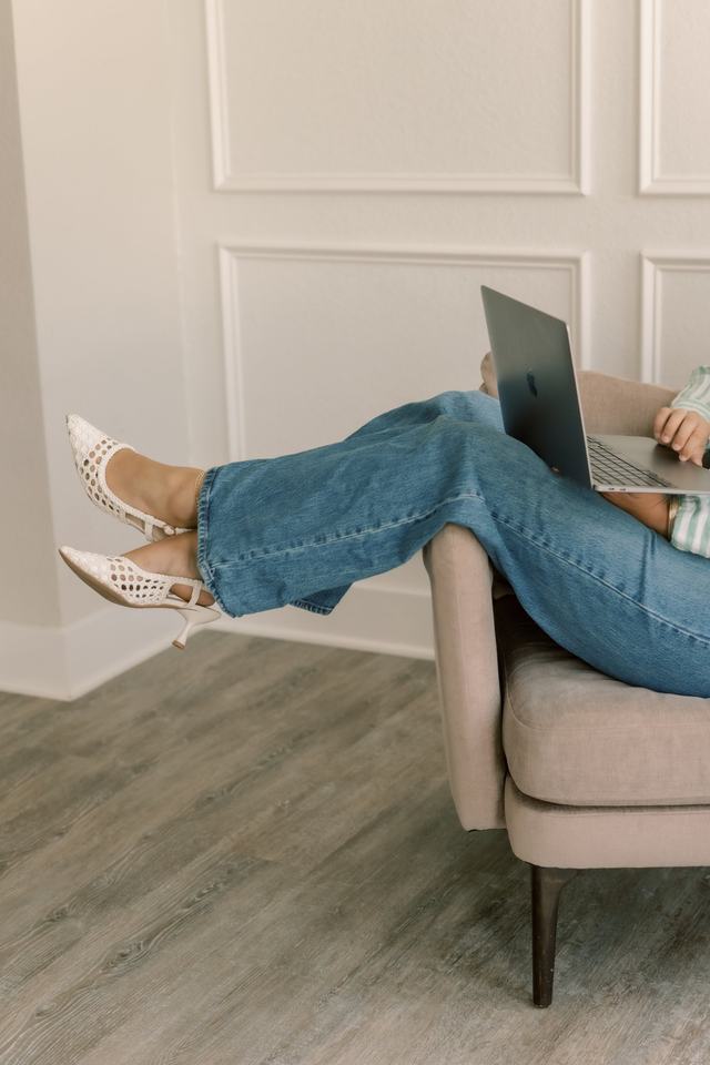Elsie with her feet up and laptop open, everything handled